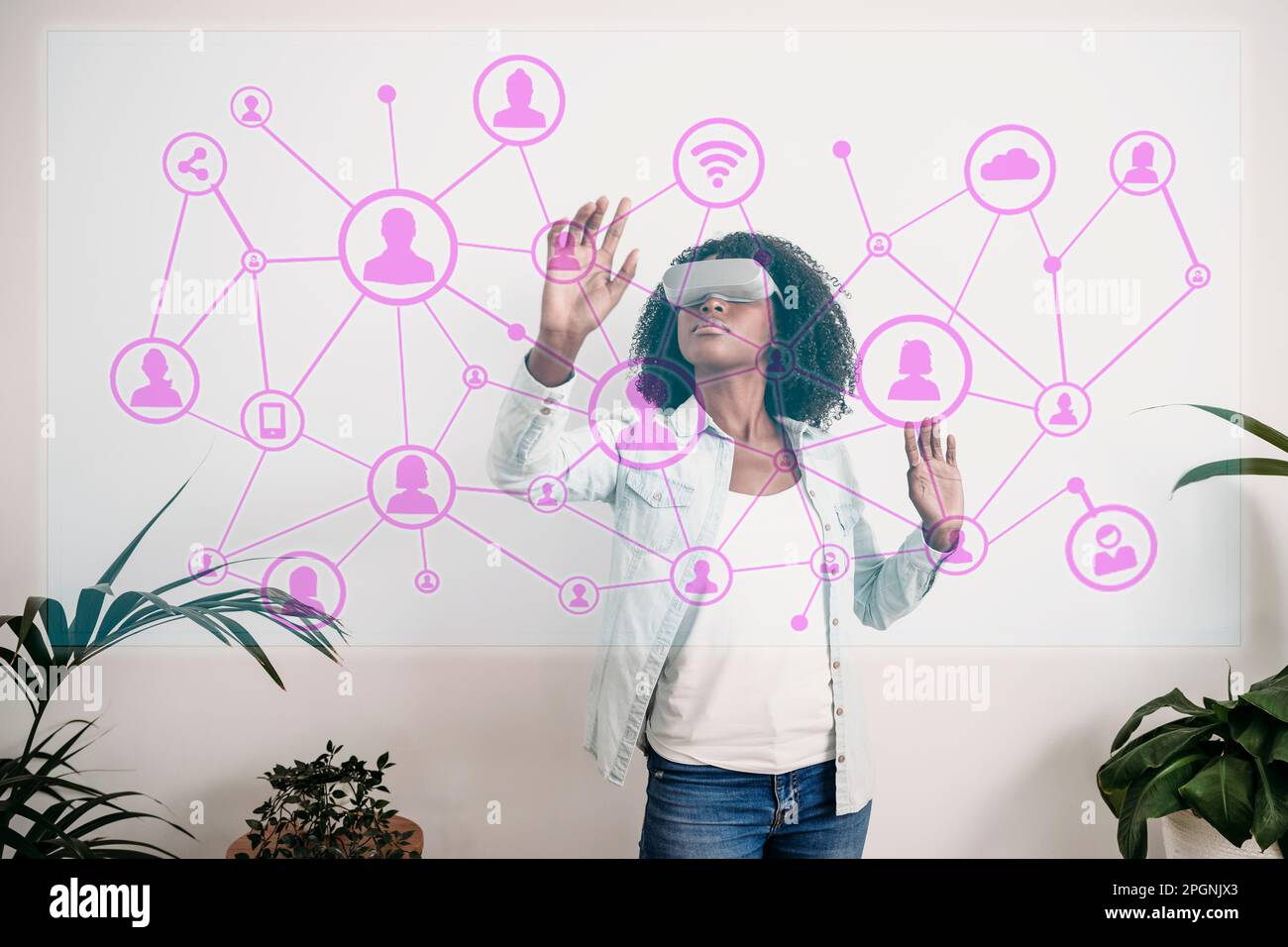 Businesswoman touching virtual network icons at home office Stock Photo