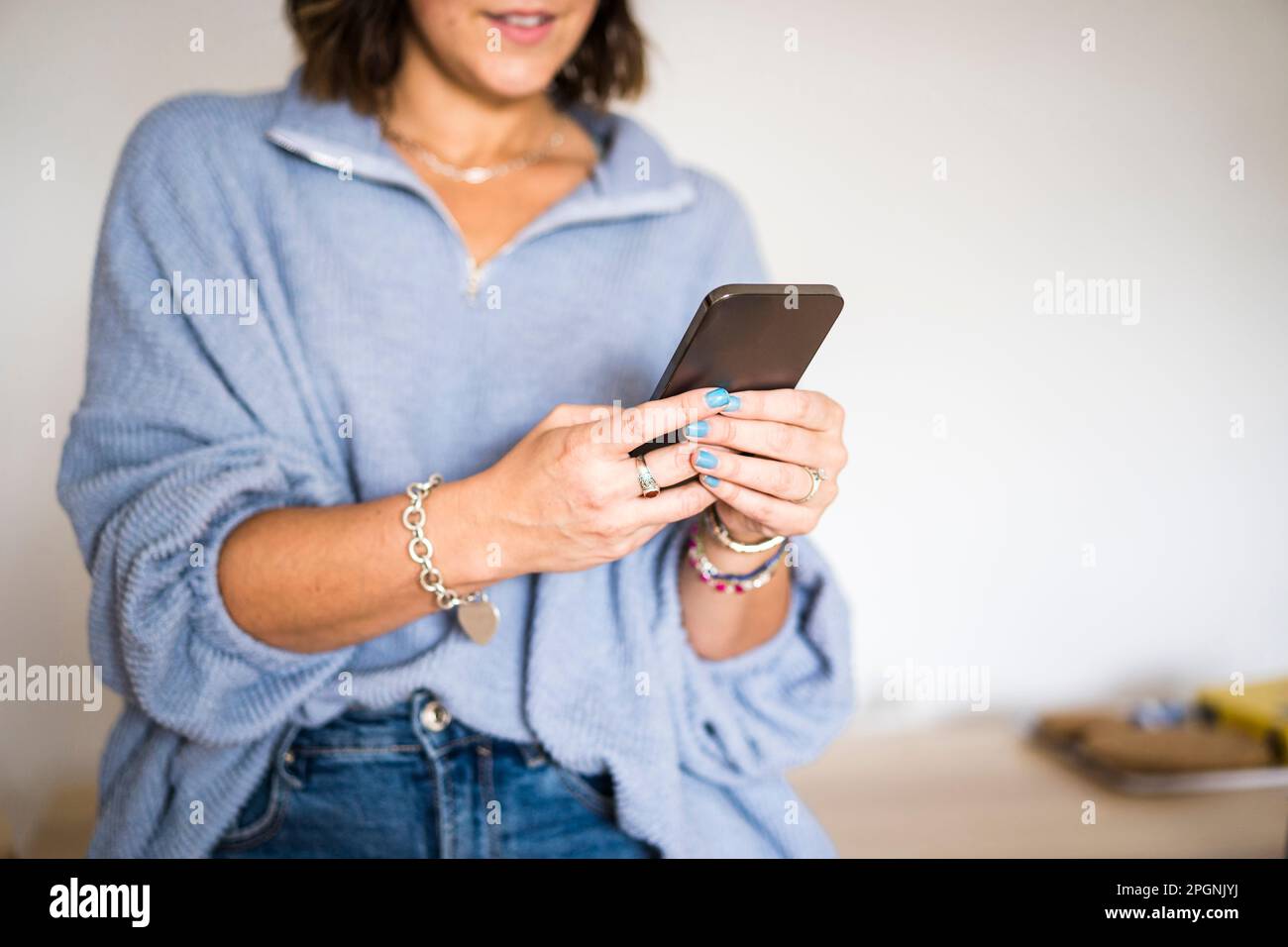 Woman using smart phone at home Stock Photo