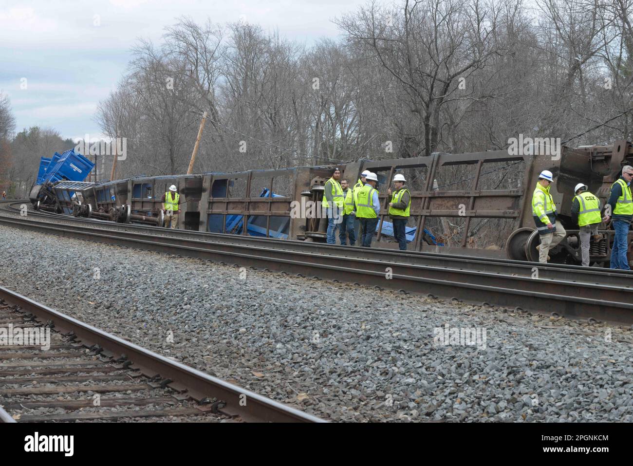 Ayer, Massachusetts, USA. 24th Mar, 2023. Derailed train cars litter the railbed at a derailment of cars operated by Springfield Terminal with Norfolk Southern engines. The cars were hauling solid waste and recyclables, but no hazardous waste as it passed through Ayer center and toppled near a stream in a local neighborhood. Work crews are on the scene and authorities are monitoring the situation. Earlier tracks were closed on both sides but now MBTA commuter trains are operating. (Credit Image: © Kenneth Martin/ZUMA Press Wire) EDITORIAL USAGE ONLY! Not for Commercial USAGE! Stock Photo