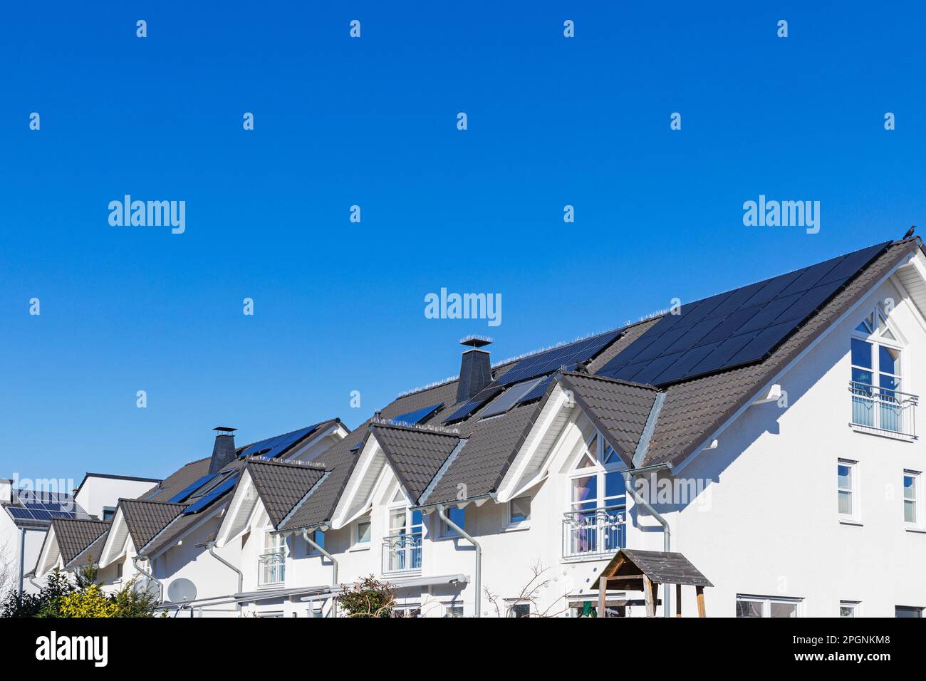 Germany, North Rhine Westphalia, Cologne, Clear sky over modern houses with solar roof panels Stock Photo