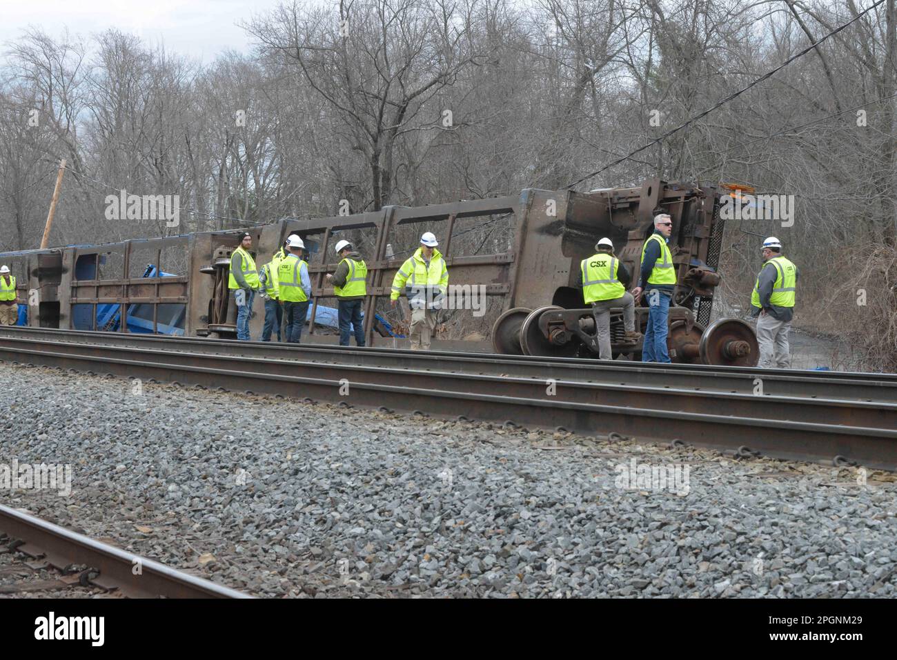 Ayer, Massachusetts, USA. 24th Mar, 2023. Derailed train cars litter the railbed at a derailment of cars operated by Springfield Terminal with Norfolk Southern engines. The cars were hauling solid waste and recyclables, but no hazardous waste as it passed through Ayer center and toppled near a stream in a local neighborhood. Work crews are on the scene and authorities are monitoring the situation. Earlier tracks were closed on both sides but now MBTA commuter trains are operating. (Credit Image: © Kenneth Martin/ZUMA Press Wire) EDITORIAL USAGE ONLY! Not for Commercial USAGE! Stock Photo