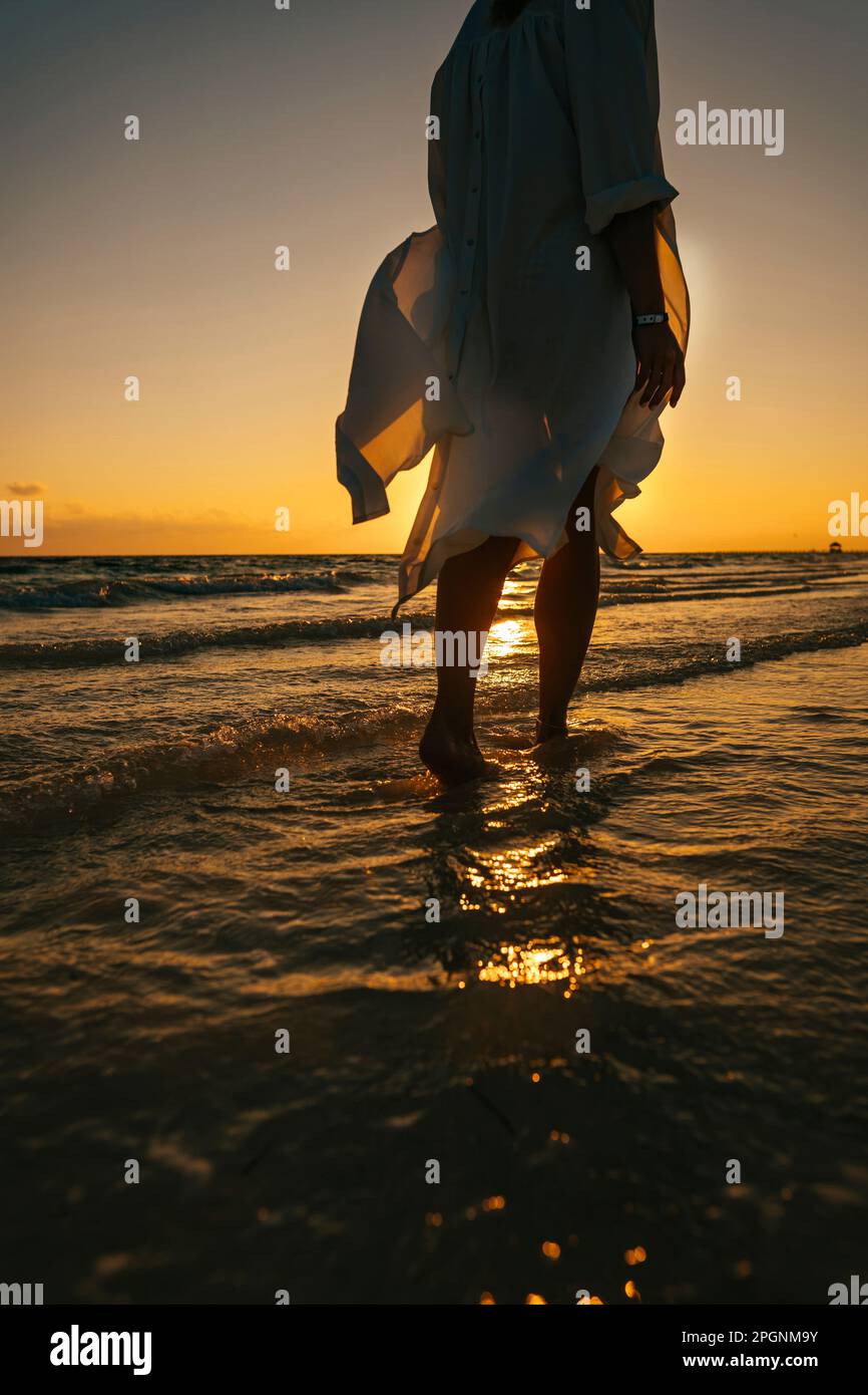 Woman walking on beach sunrise hi-res stock photography and images - Alamy