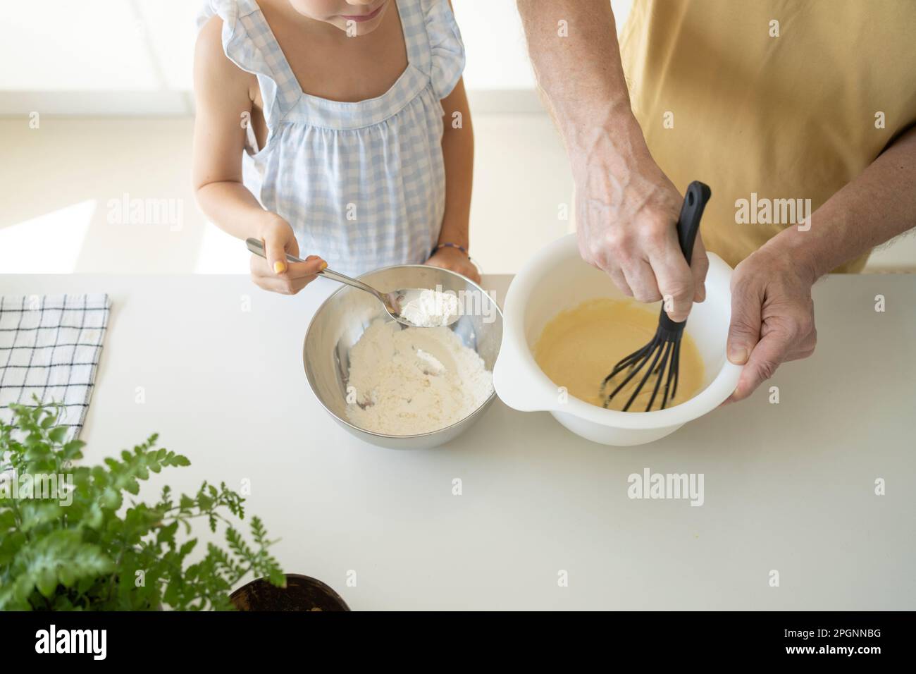Girl adding flour in batter for preparing dough Stock Photo Alamy
