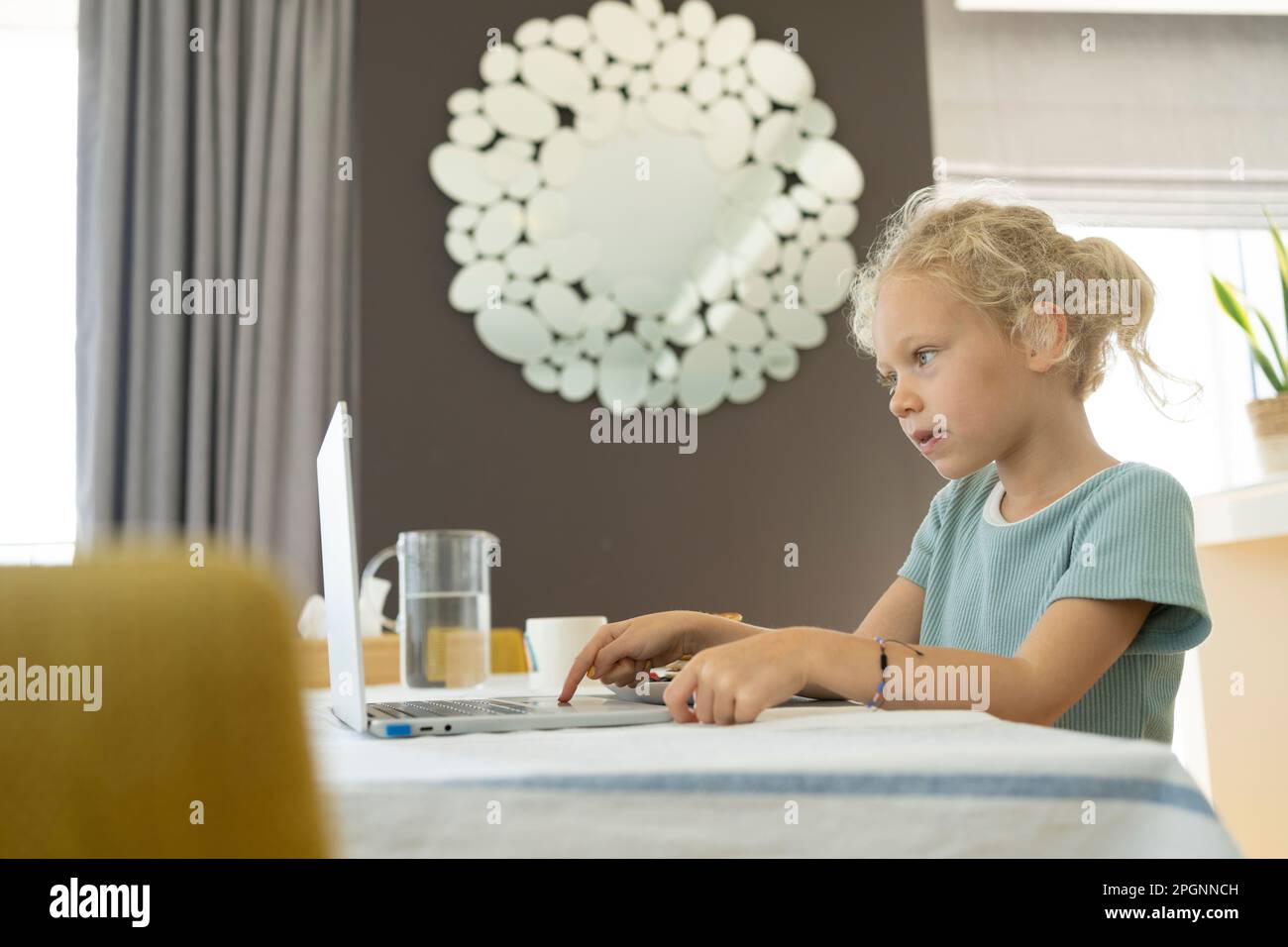 Girl using laptop at home Stock Photo