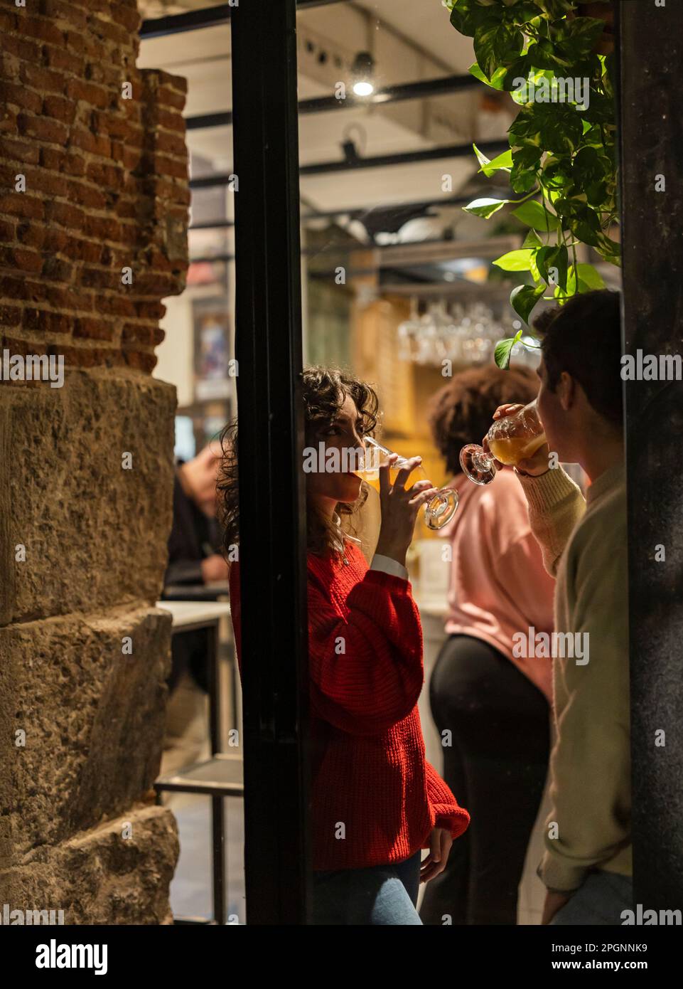 Young friends having drinks seen through glass Stock Photo