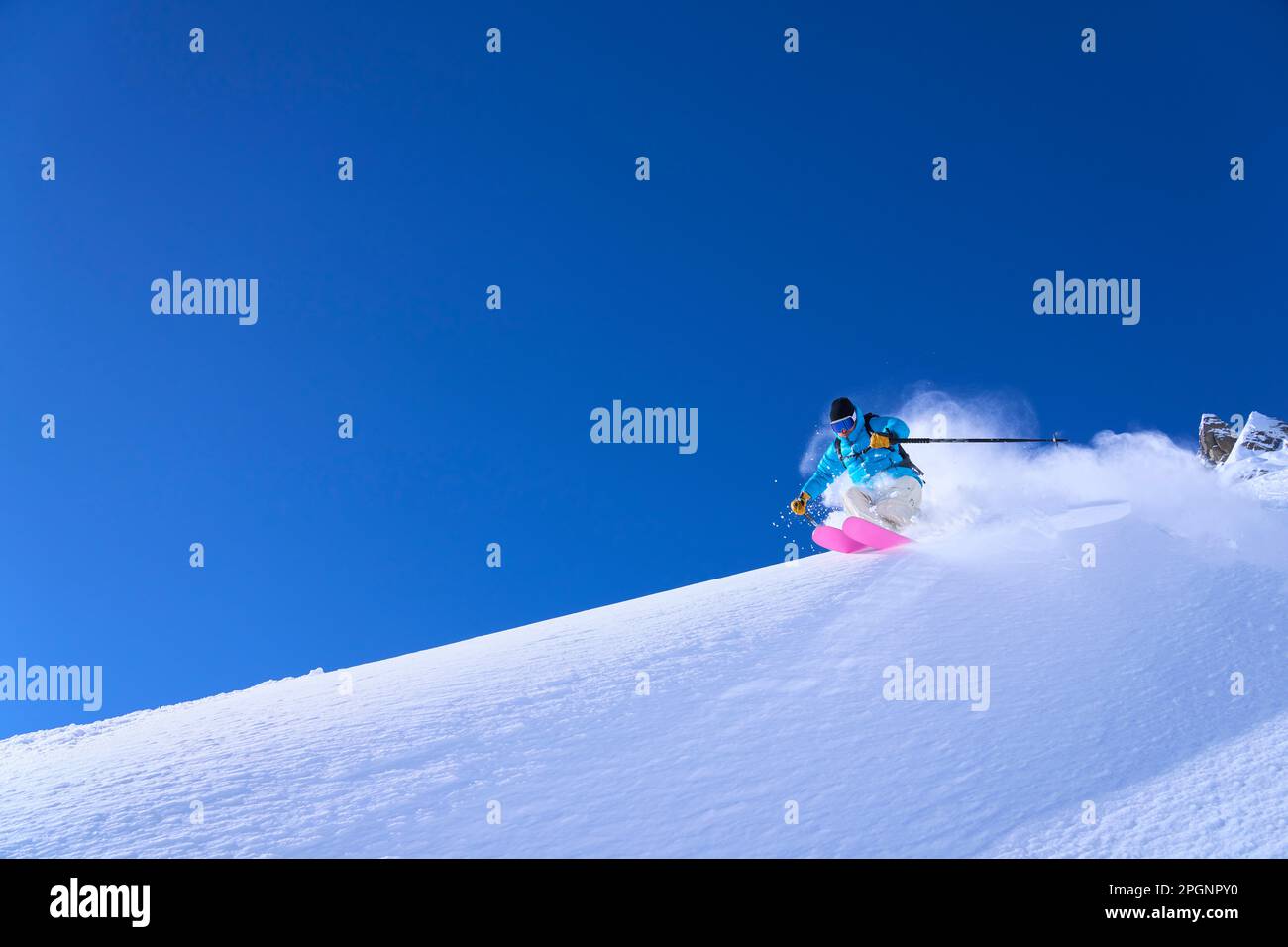 Man wearing skies skiing on snow Stock Photo