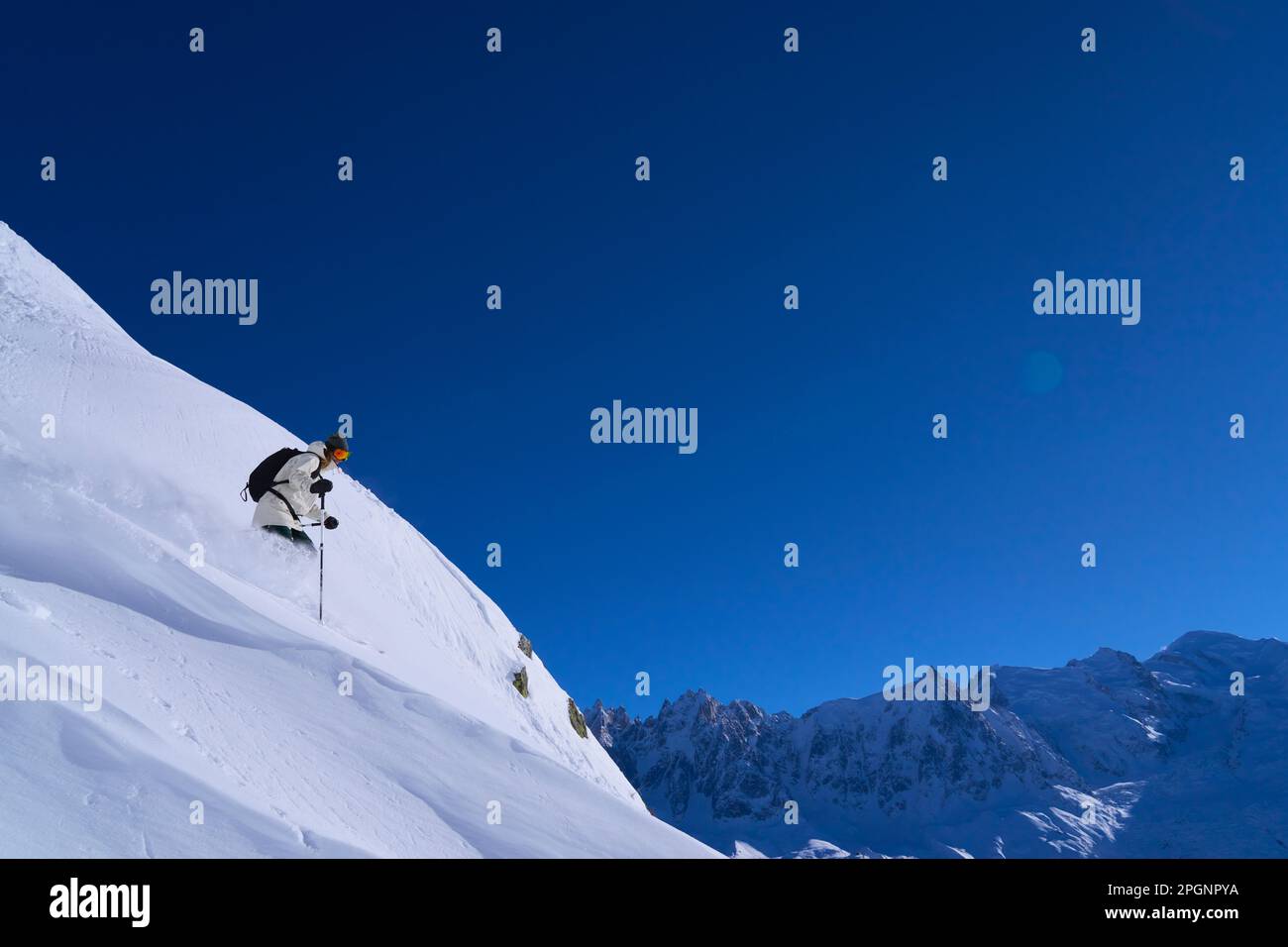 Woman skiing down on slopes Stock Photo