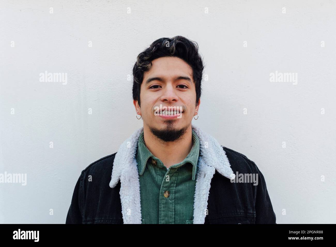 Young man standing front wall hi-res stock photography and images - Alamy