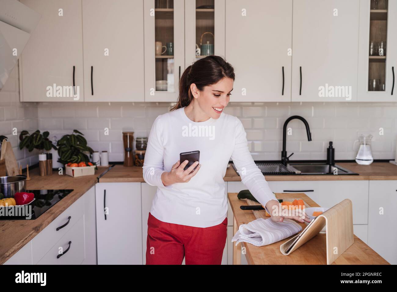 Happy woman touching tablet pc hi-res stock photography and images - Alamy