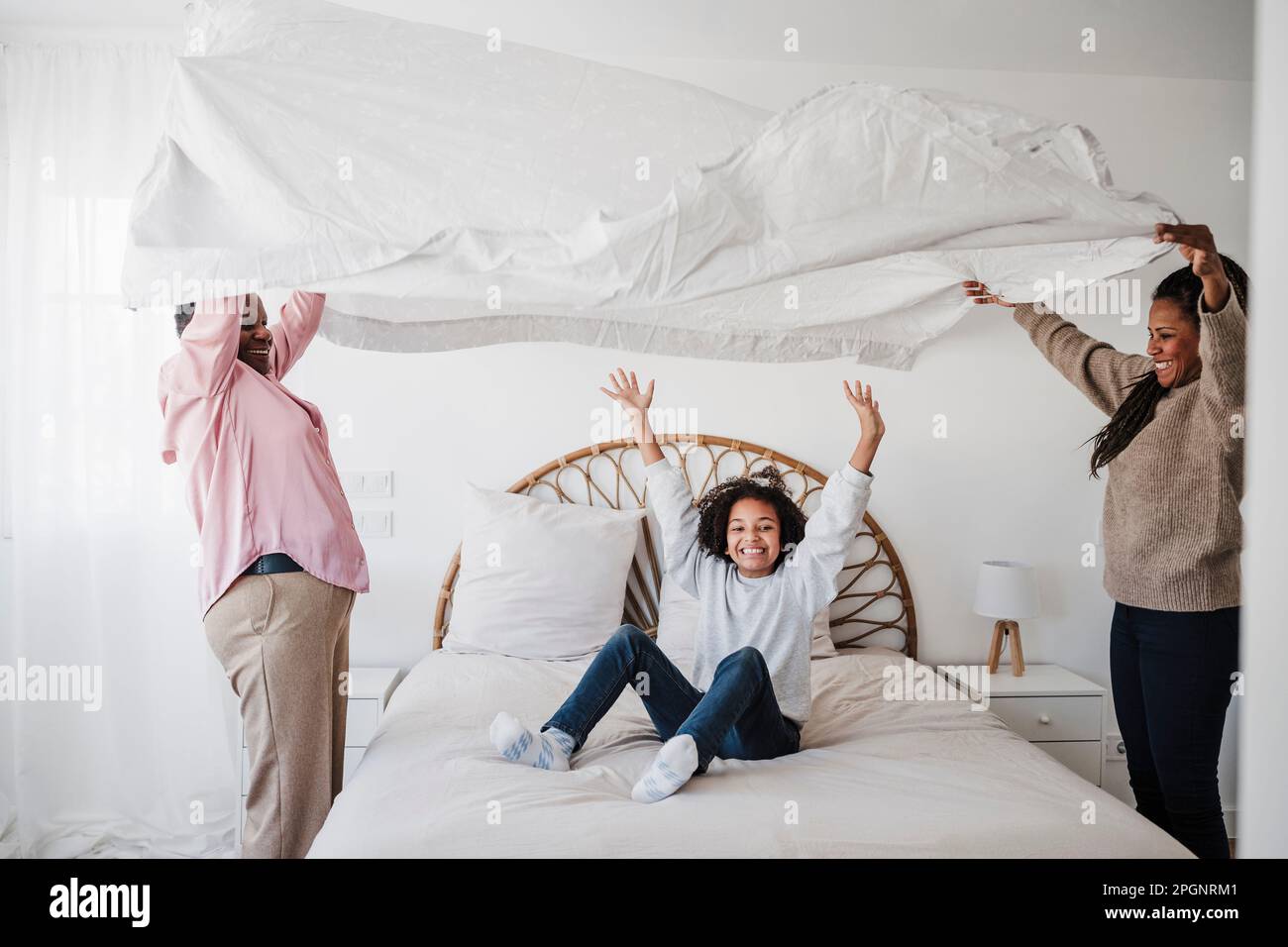 Happy family enjoying together in bedroom at home Stock Photo