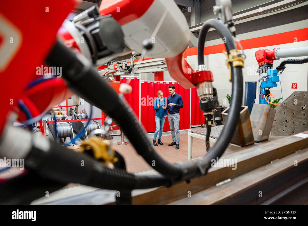 Technicians using tablet PC standing in industry Stock Photo
