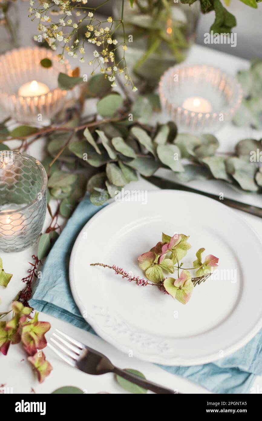 Leaves on plate lying on set table Stock Photo
