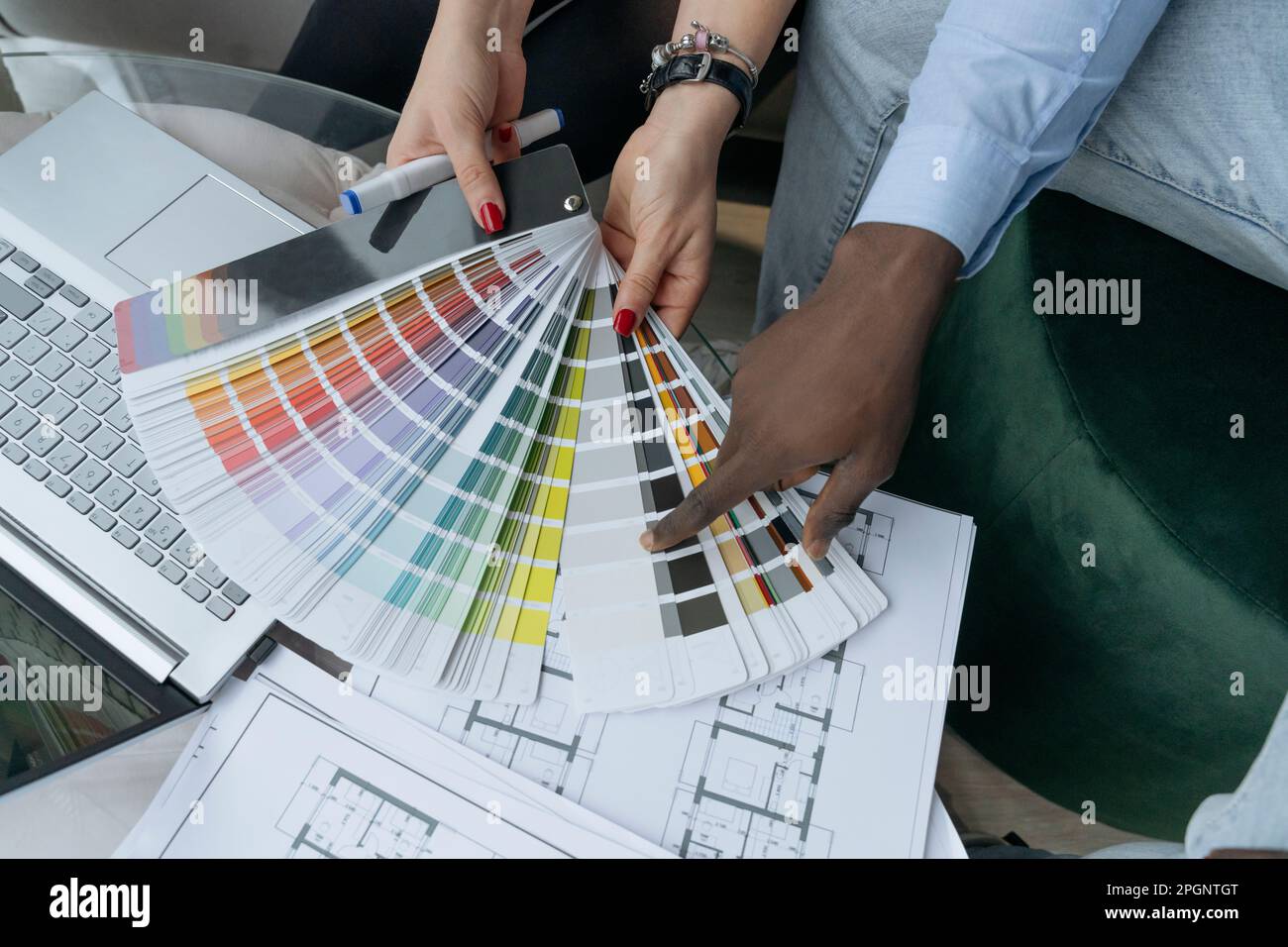Businessman pointing on color shade by colleague at workplace Stock Photo