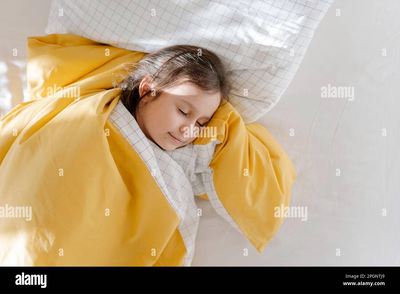 Girl sleeping with blanket on bed Stock Photo Alamy