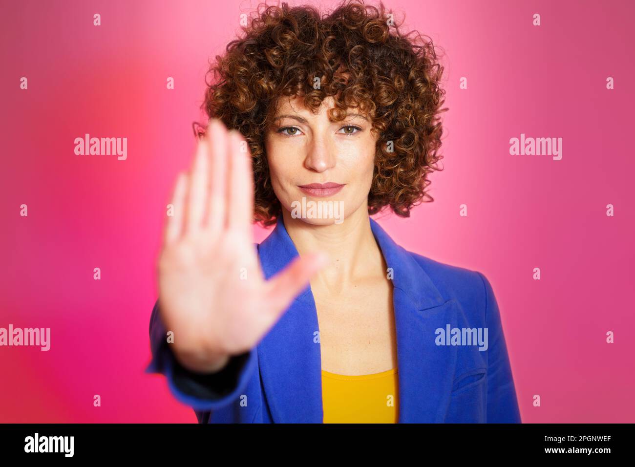Woman stop gesturing against magenta background Stock Photo