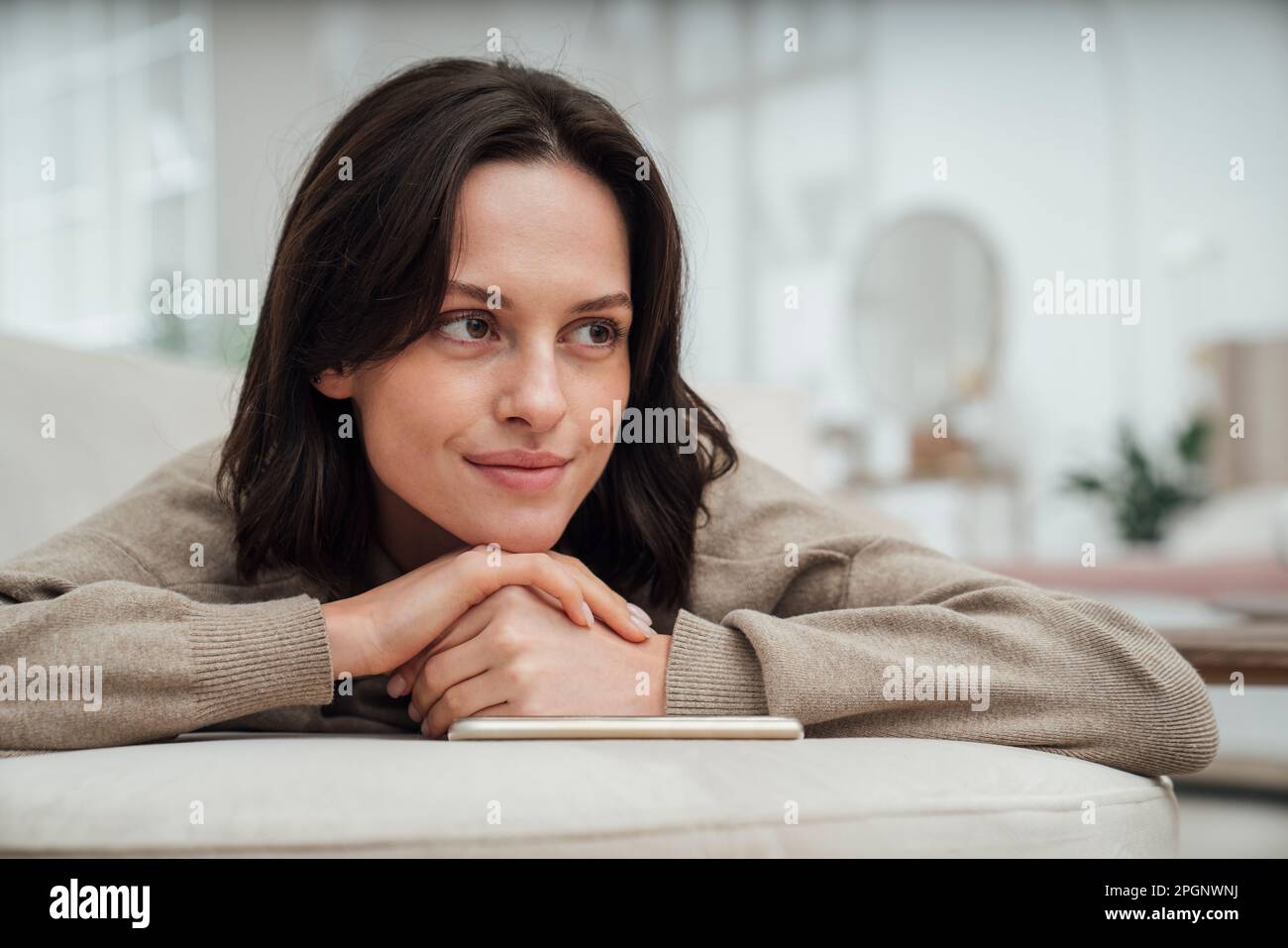 Casual woman lying on sofa hi-res stock photography and images - Alamy