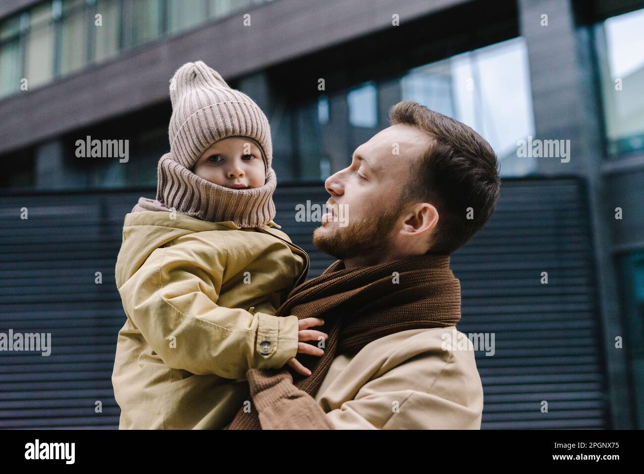 Father with son standing in front of building Stock Photo - Alamy