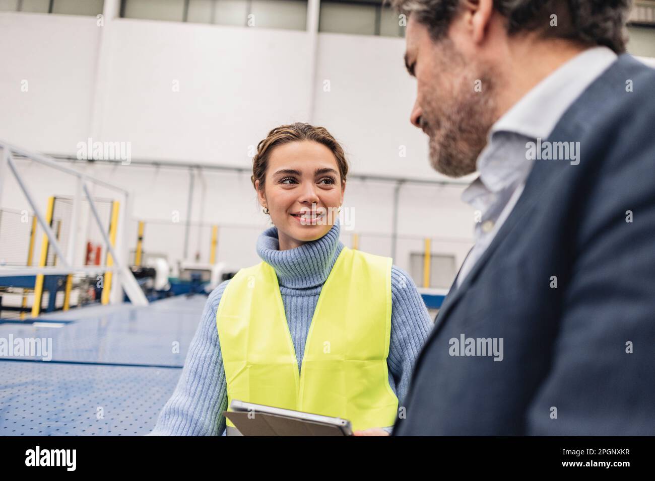 Smiling engineer with colleague working in office Stock Photo