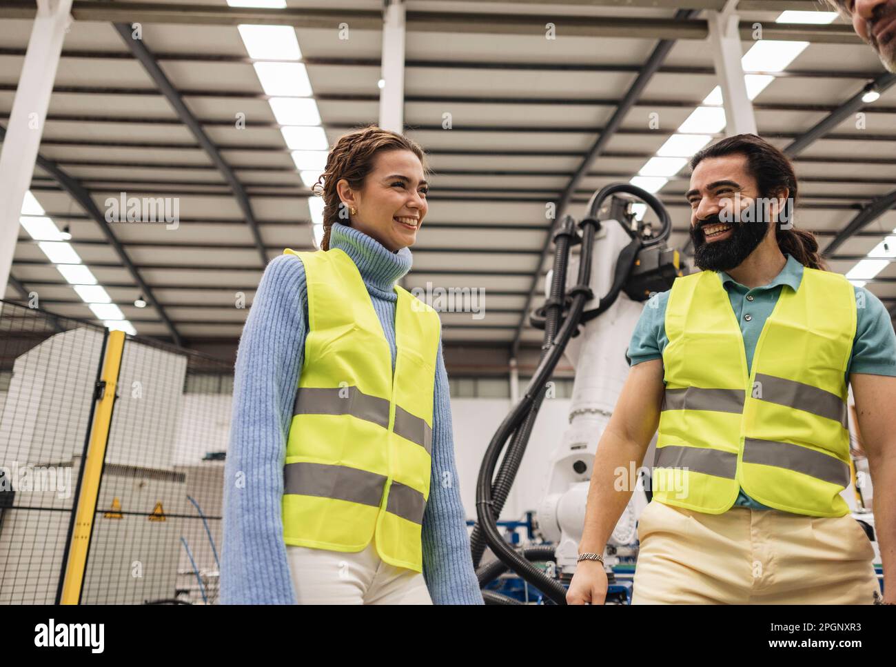 Happy engineers having fun in robotics factory Stock Photo Alamy