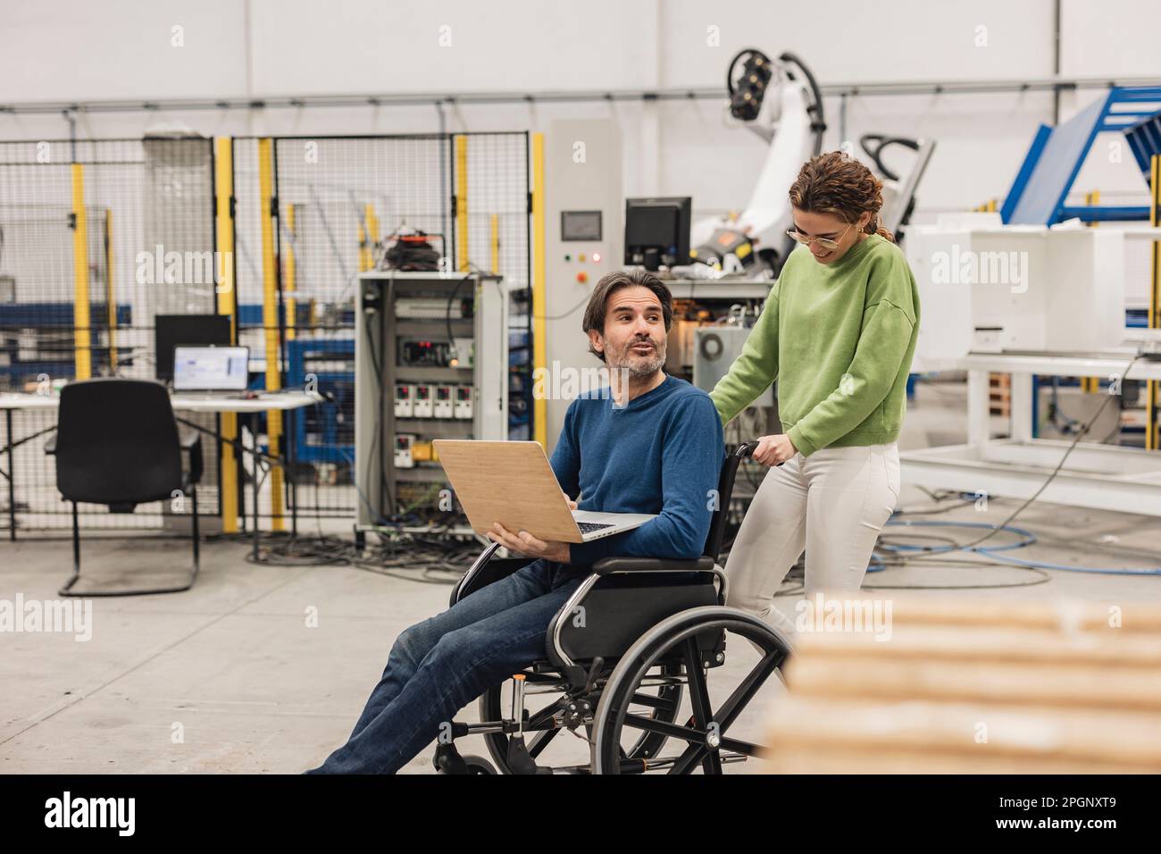Man pushing coworker in wheelchair hi-res stock photography and images ...