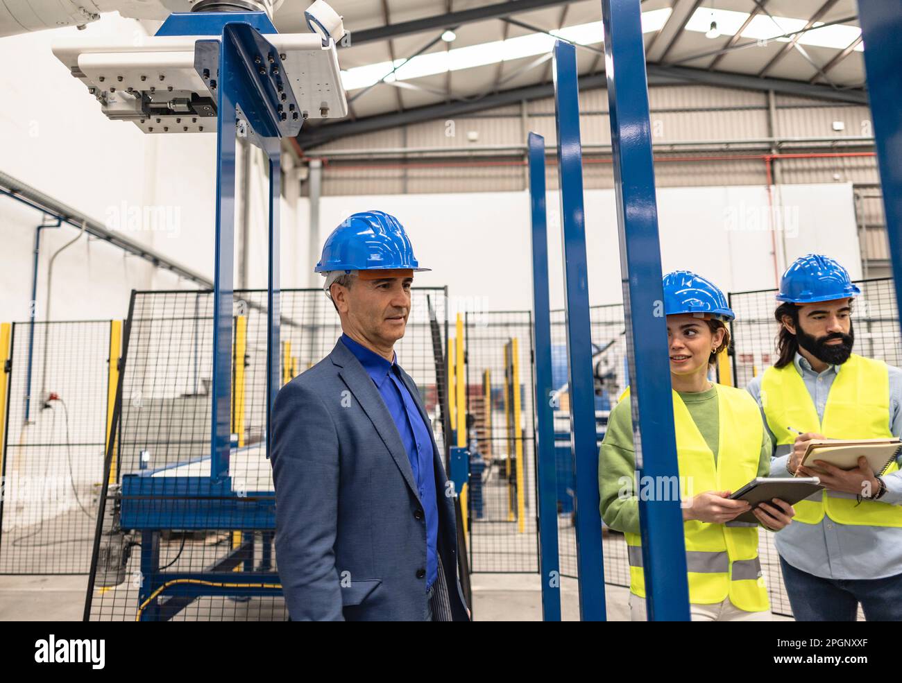 Thoughtful engineer with colleagues in factory Stock Photo
