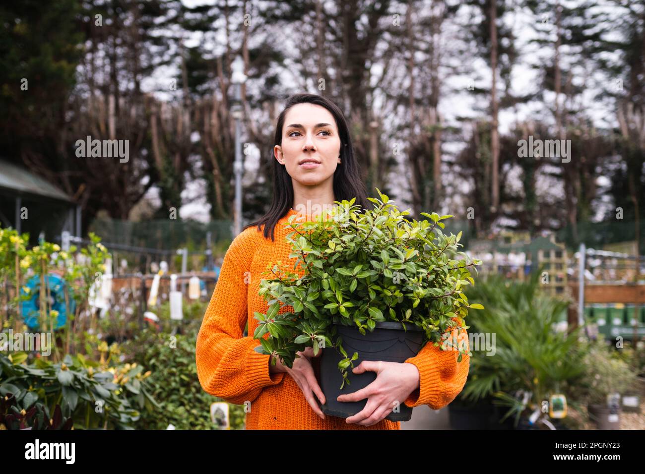 Young woman in garden center hi-res stock photography and images - Alamy