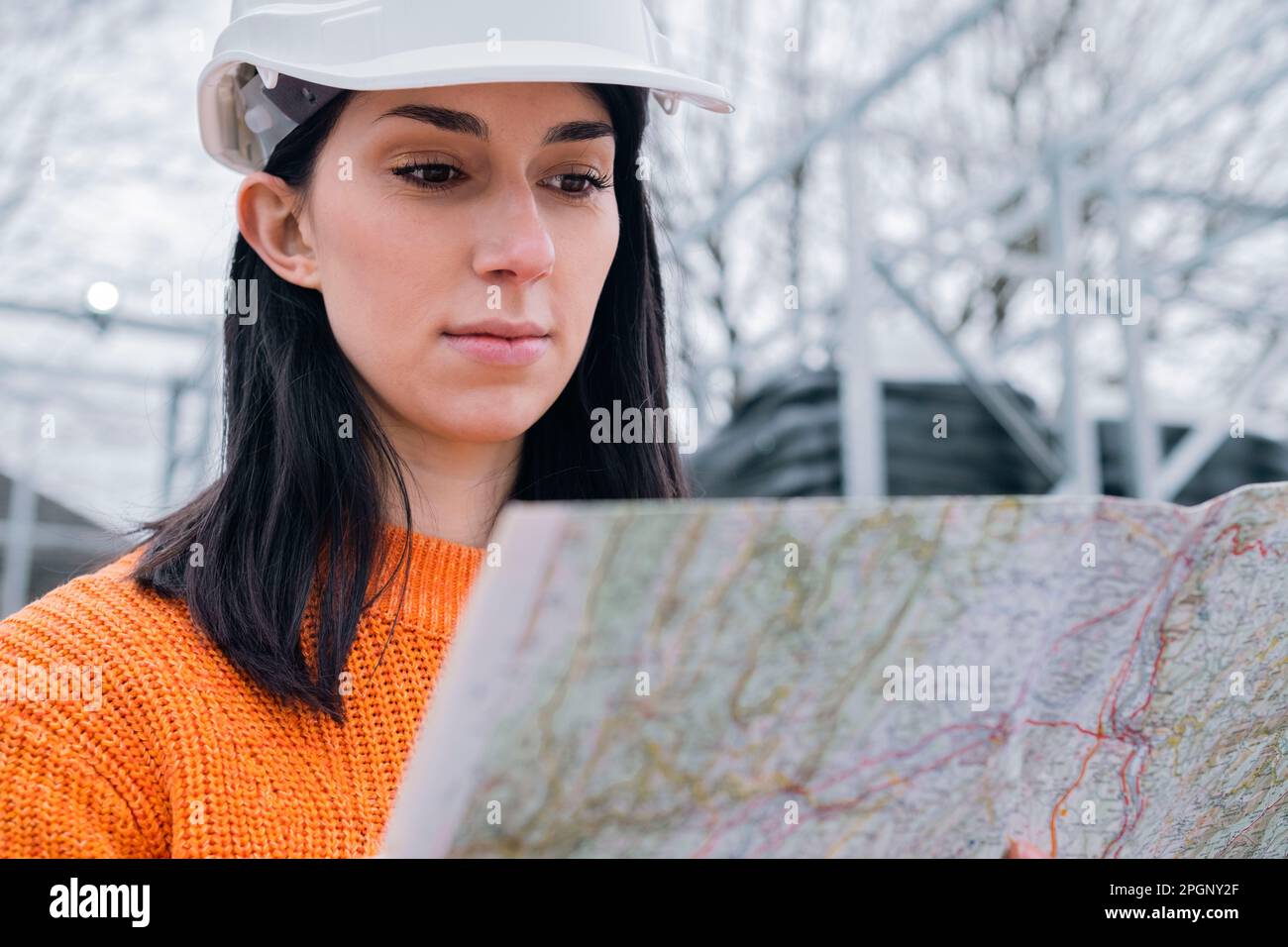 Young woman examining map at site Stock Photo