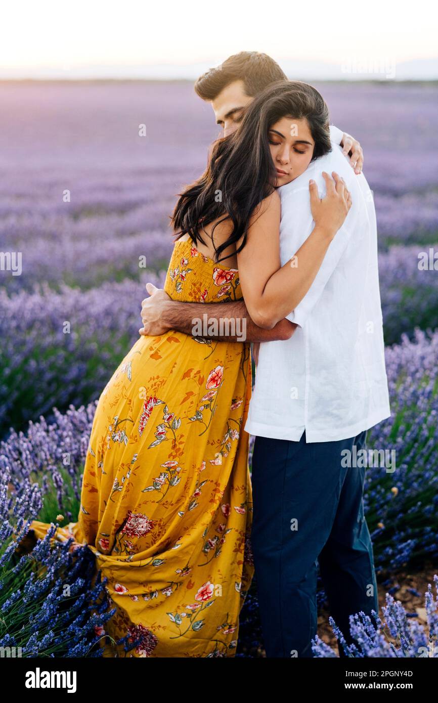 Affectionate young woman hugging boyfriend hi-res stock photography and ...