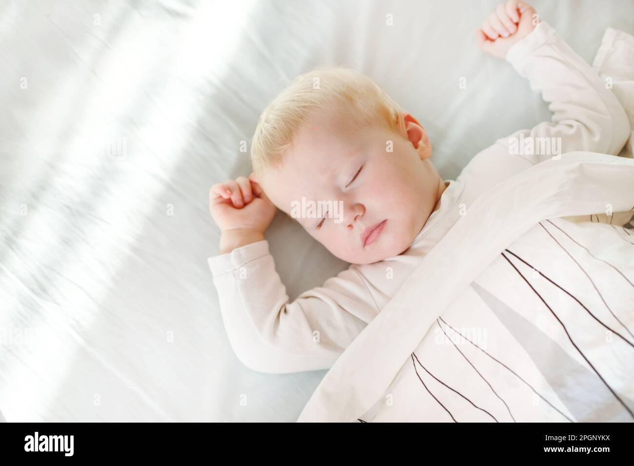 portrait of adorable baby girl sleeping in bed. baby napping during