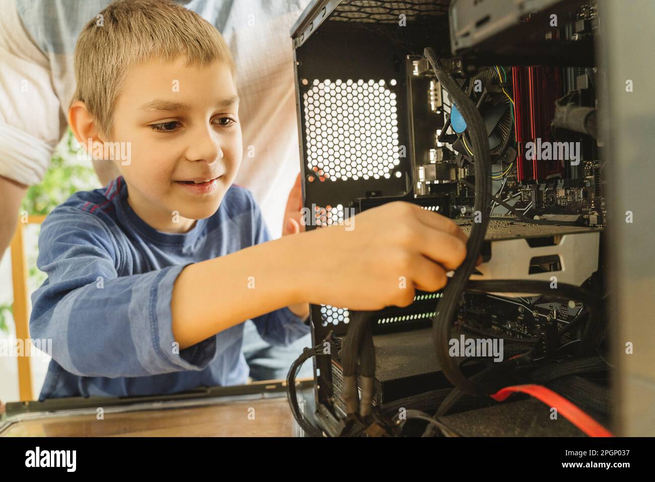 Smiling boy cleaning computer parts at home Stock Photo Alamy