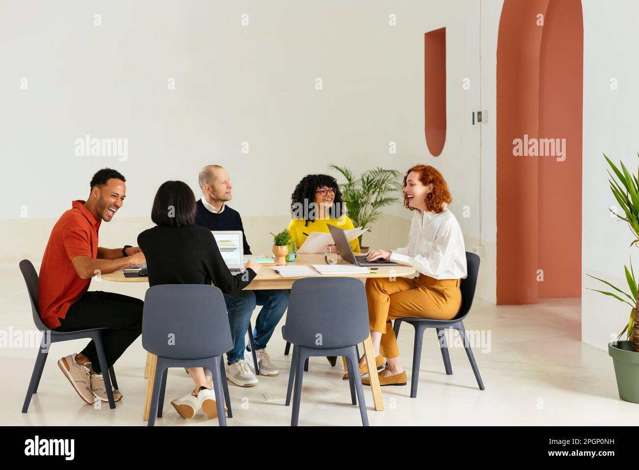 Multiracial colleagues discussing in meeting room at office Stock Photo ...
