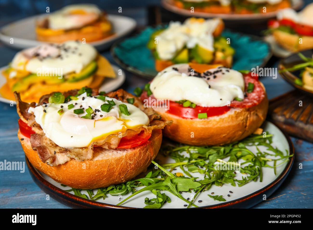 Plates with tasty eggs Benedict on table, closeup Stock Photo