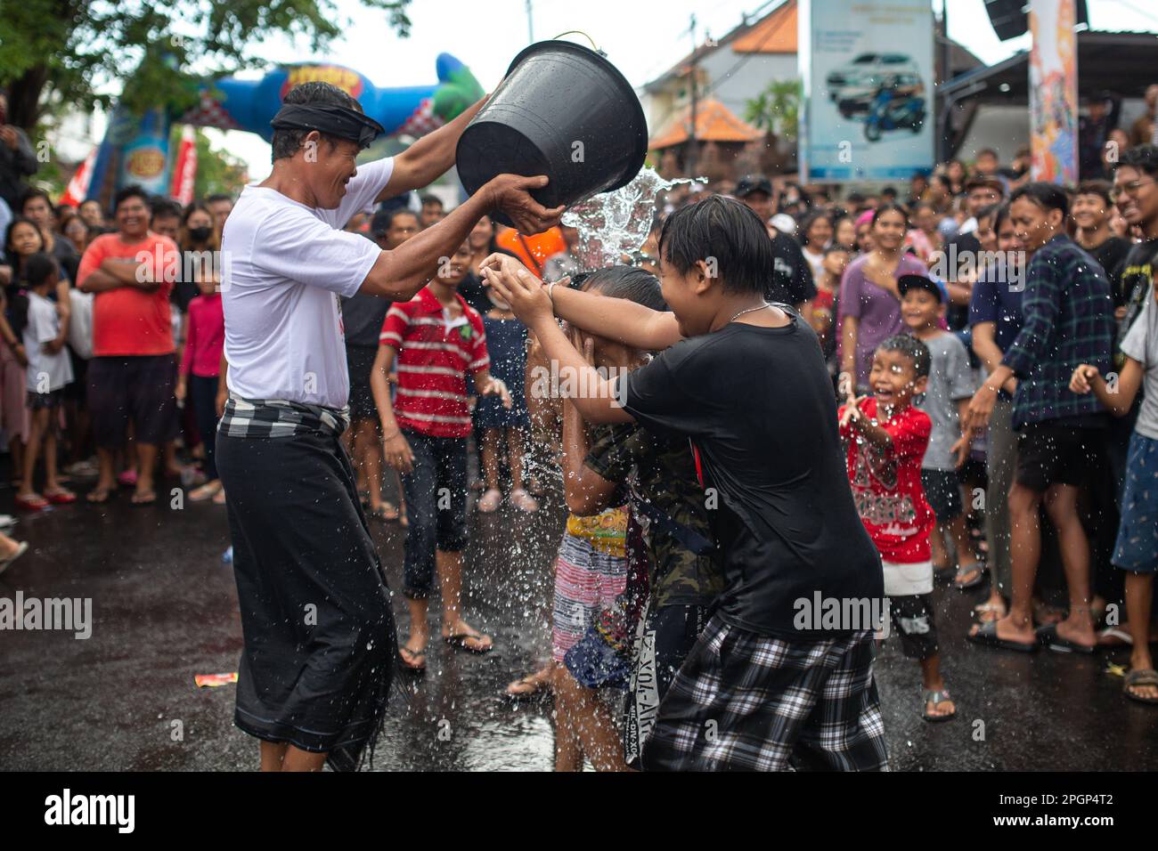 Denpasar, Bali, Indonesia - March 23, 2023: Omed-Omedan festival also known as The Kissing Ritual on the streets of Denpasar, Bali, Indonesia. Stock Photo