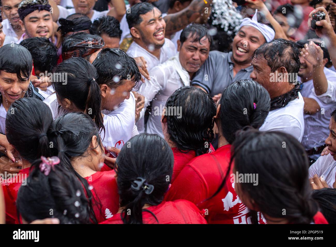 Denpasar, Bali, Indonesia - March 23, 2023: Omed-Omedan festival also known as The Kissing Ritual on the streets of Denpasar, Bali, Indonesia. Stock Photo