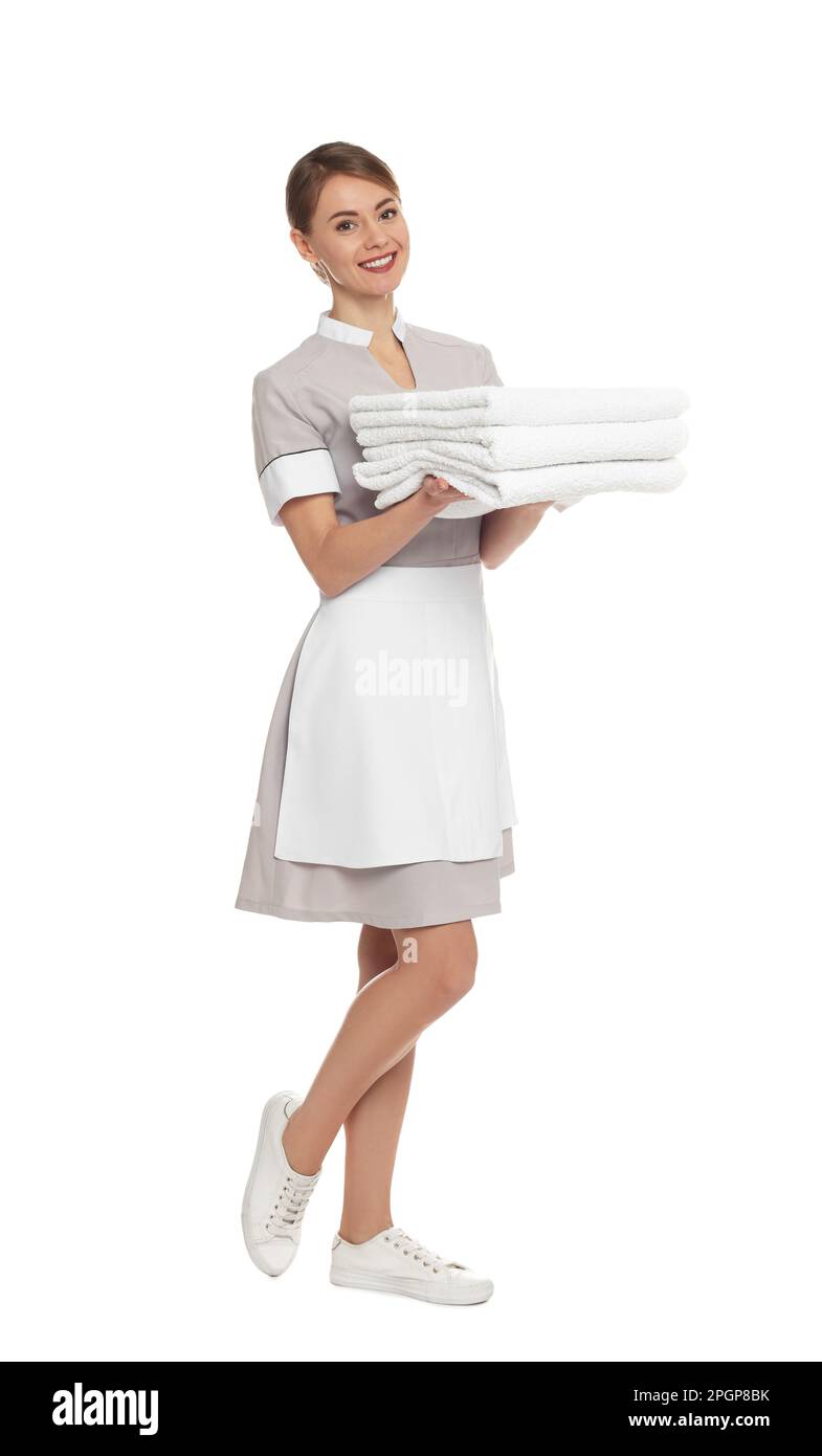 Full length portrait of chambermaid with towels on white background Stock Photo