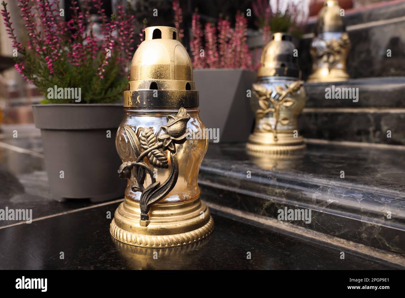 Golden grave lanterns on granite stairs at cemetery Stock Photo - Alamy