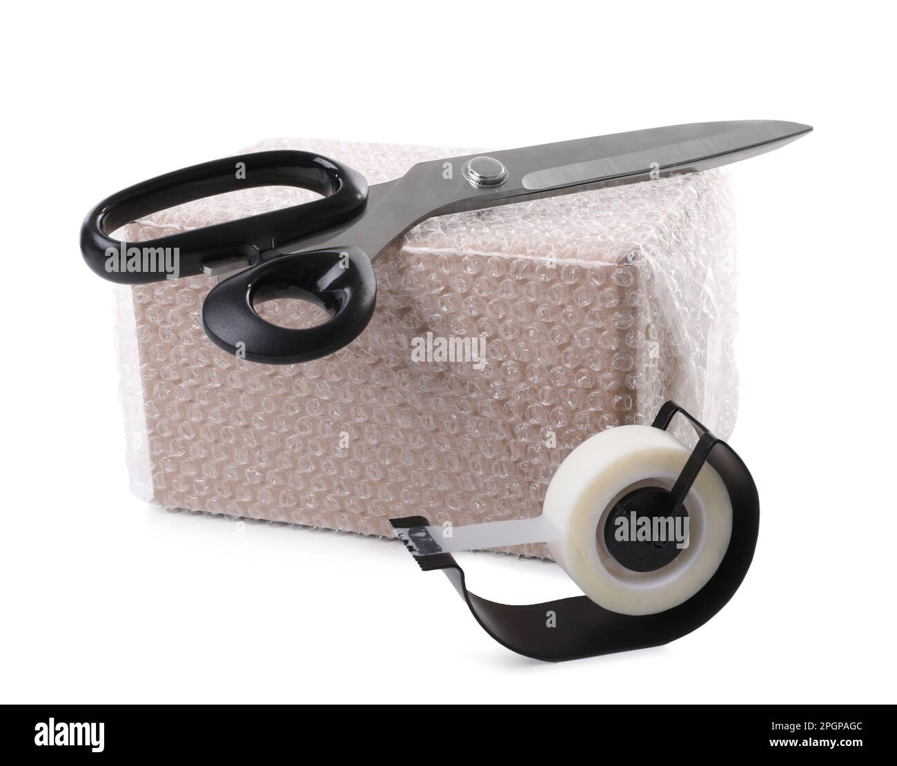 https://c8.alamy.com/comp/2PGPAGC/cardboard-box-packed-in-bubble-wrap-scissors-and-adhesive-tape-on-white-background-2PGPAGC.jpg