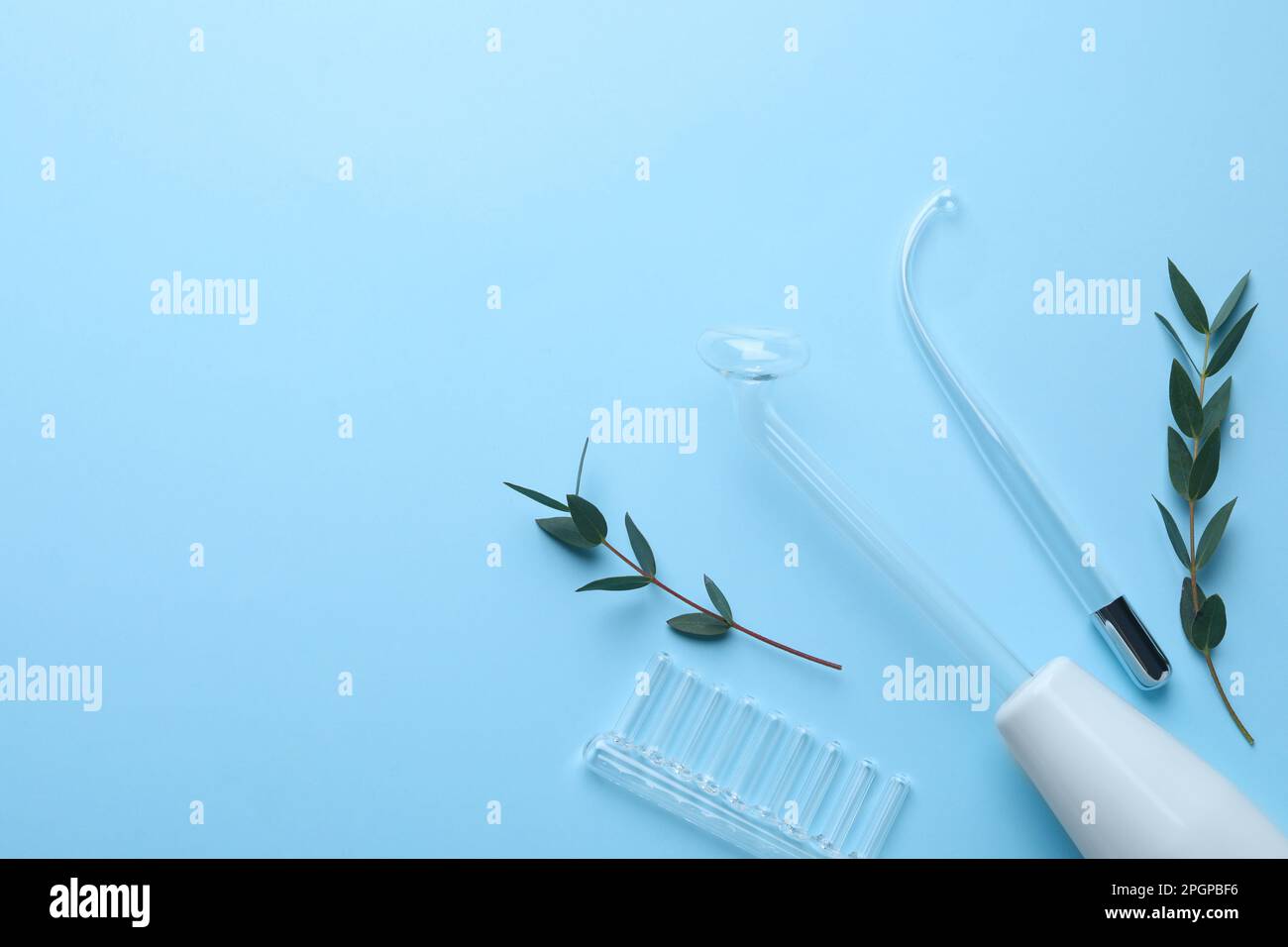 Modern darsonval with nozzles and tree branches on light blue ...