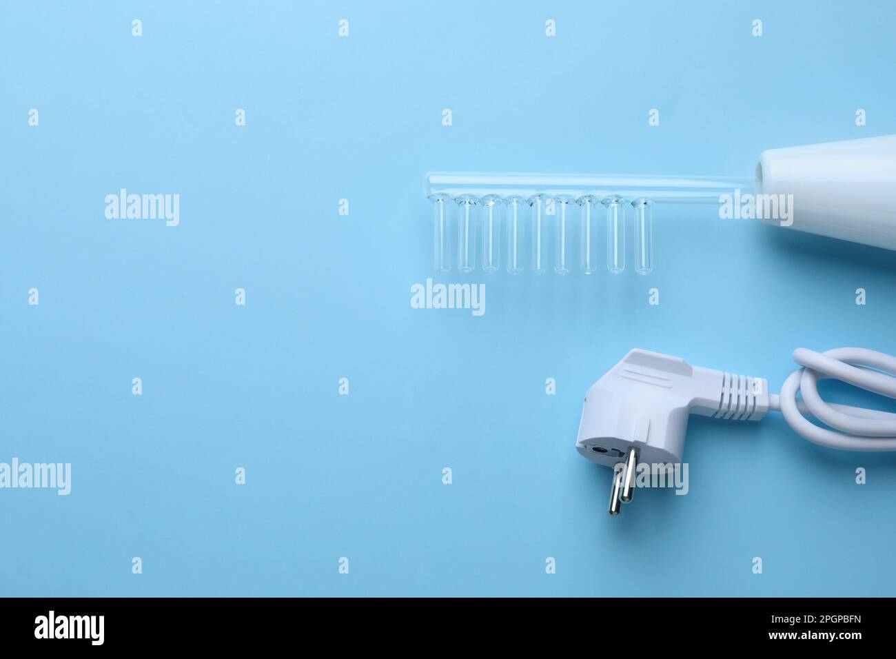 Modern darsonval on light blue background, flat lay. Space for text ...