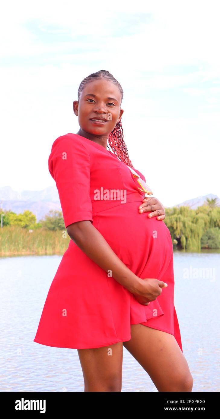 Pregnant woman wearing red dress hi-res stock photography and images ...