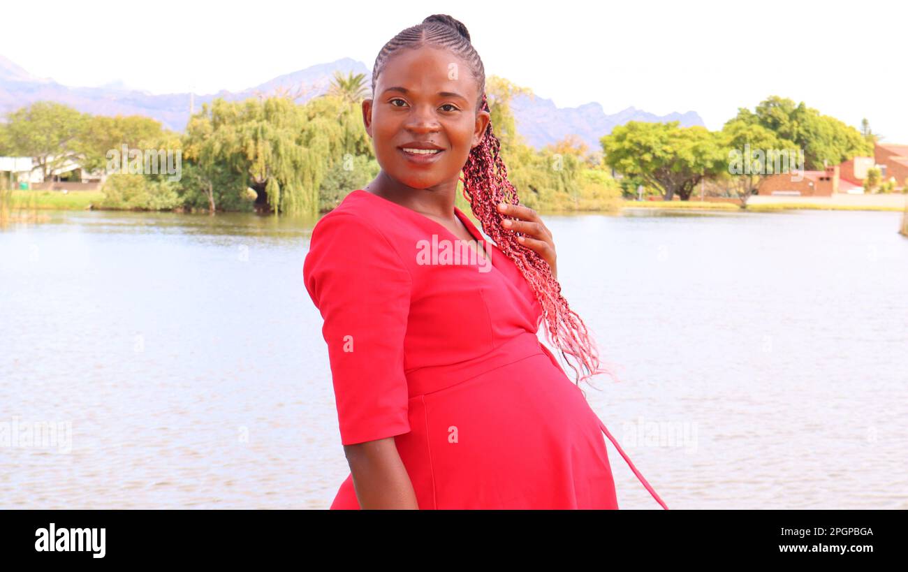 Pregnant woman wearing red hi-res stock photography and images - Alamy