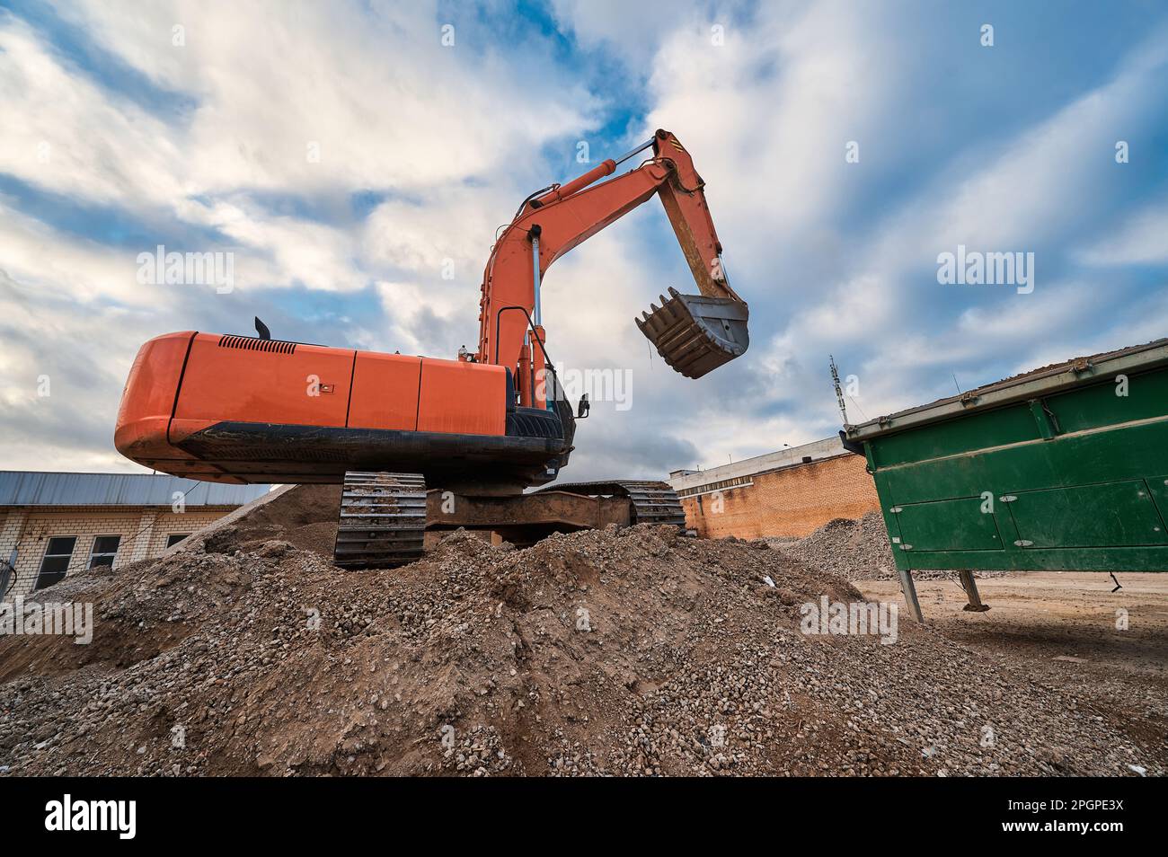 Excavator digs Sand and gravel with bucket at construction site Stock ...