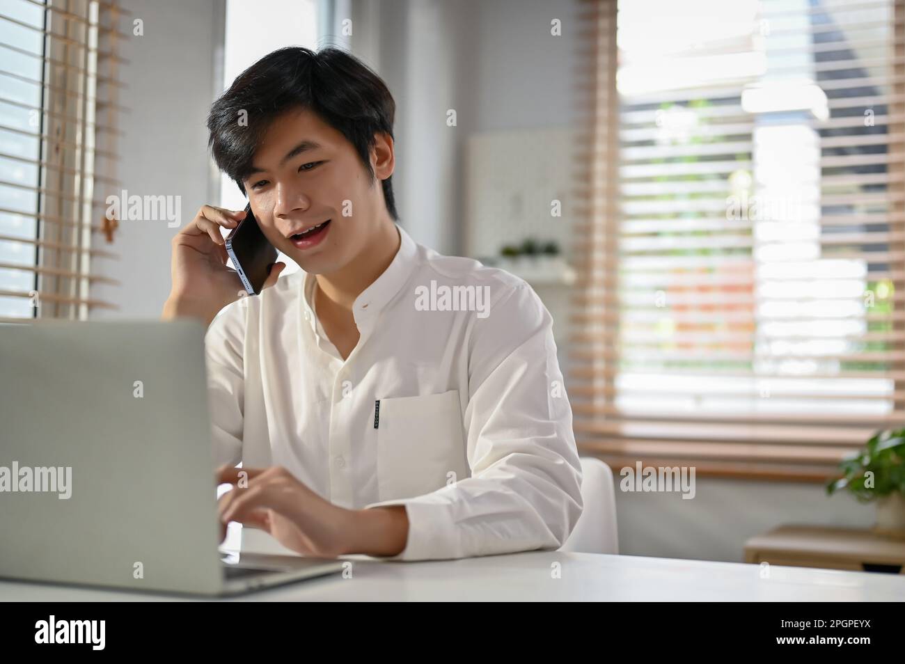 Smart and professional millennial Asian businessman talking on the ...