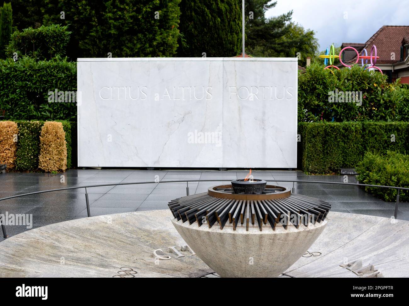 LAUSANNE, SWITZERLAND - JULY 5, 2014: Torch at the Olympic Museum, with sign reading Faster, Higher, Stronger. Stock Photo