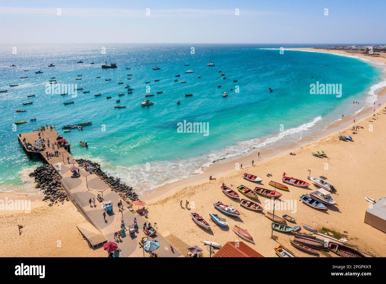 Pier and boats on turquoise water in city of Santa Maria, island of Sal, Cape Verde Stock Photo
