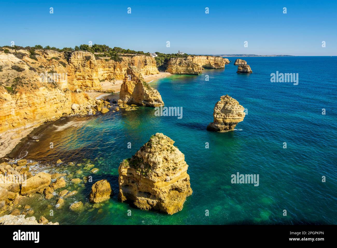 Beautiful cliffs and rock formations by the Atlantic Ocean at Marinha Beach in Algarve, Portugal Stock Photo