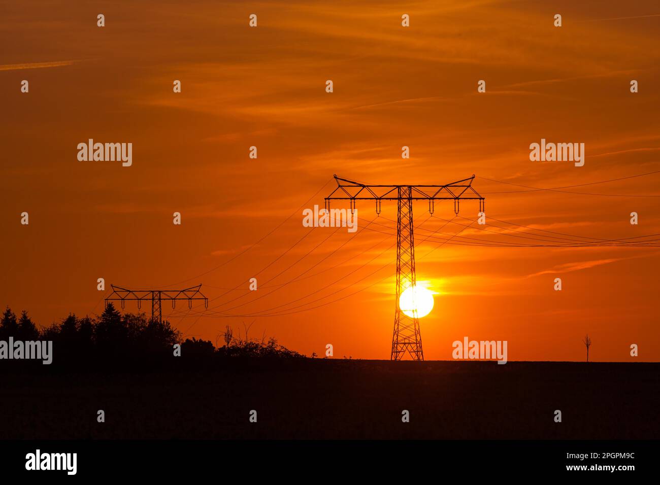 Highvoltage power line Highvoltage pylon in the sunset Stock Photo