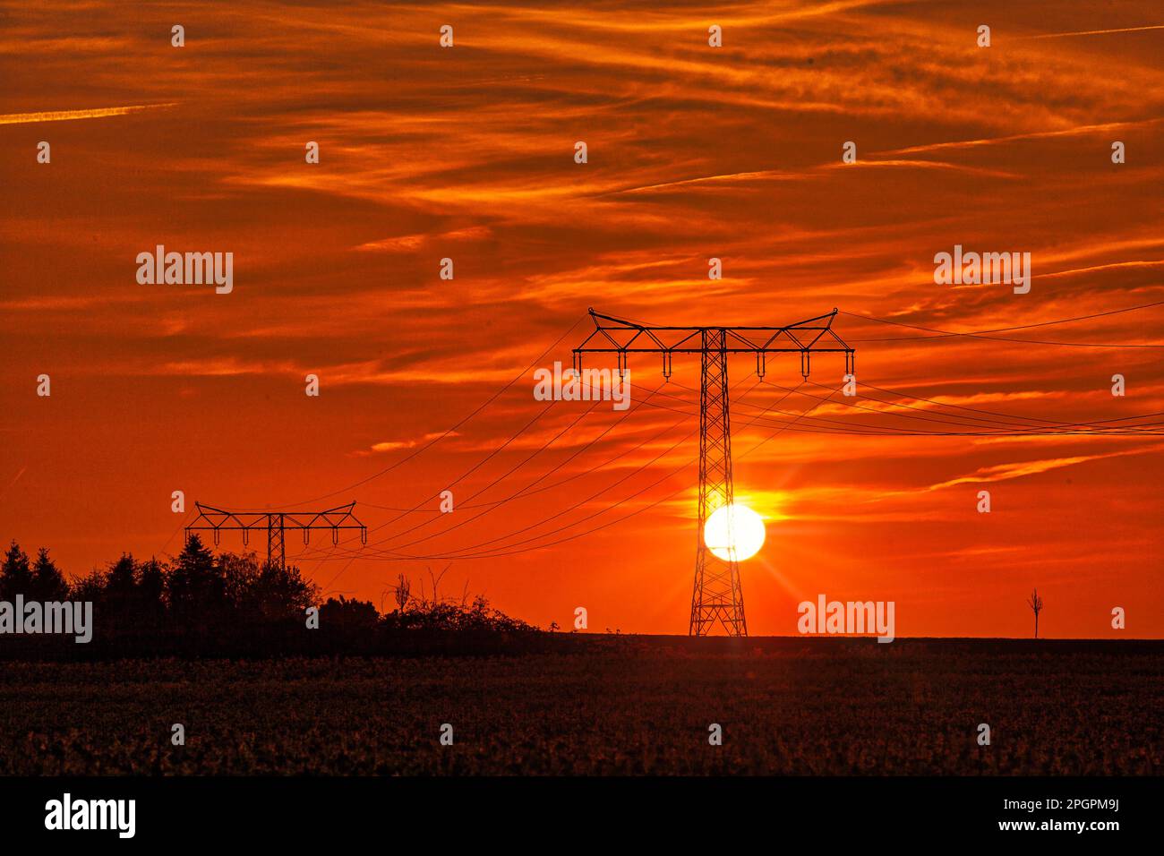 Highvoltage power line Highvoltage pylon in the sunset Stock Photo