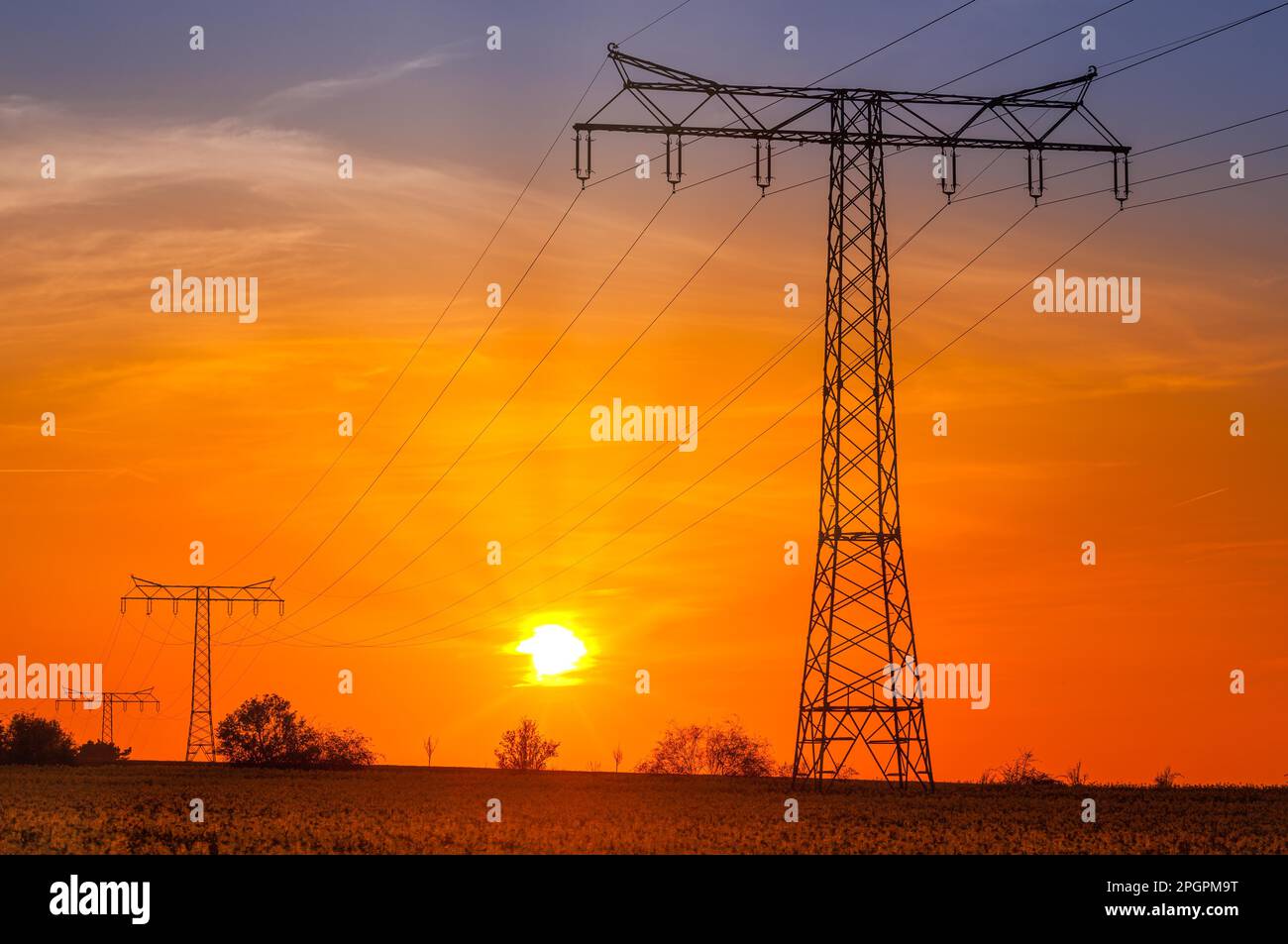 High-voltage power line High-voltage pylon in the sunset Stock Photo ...