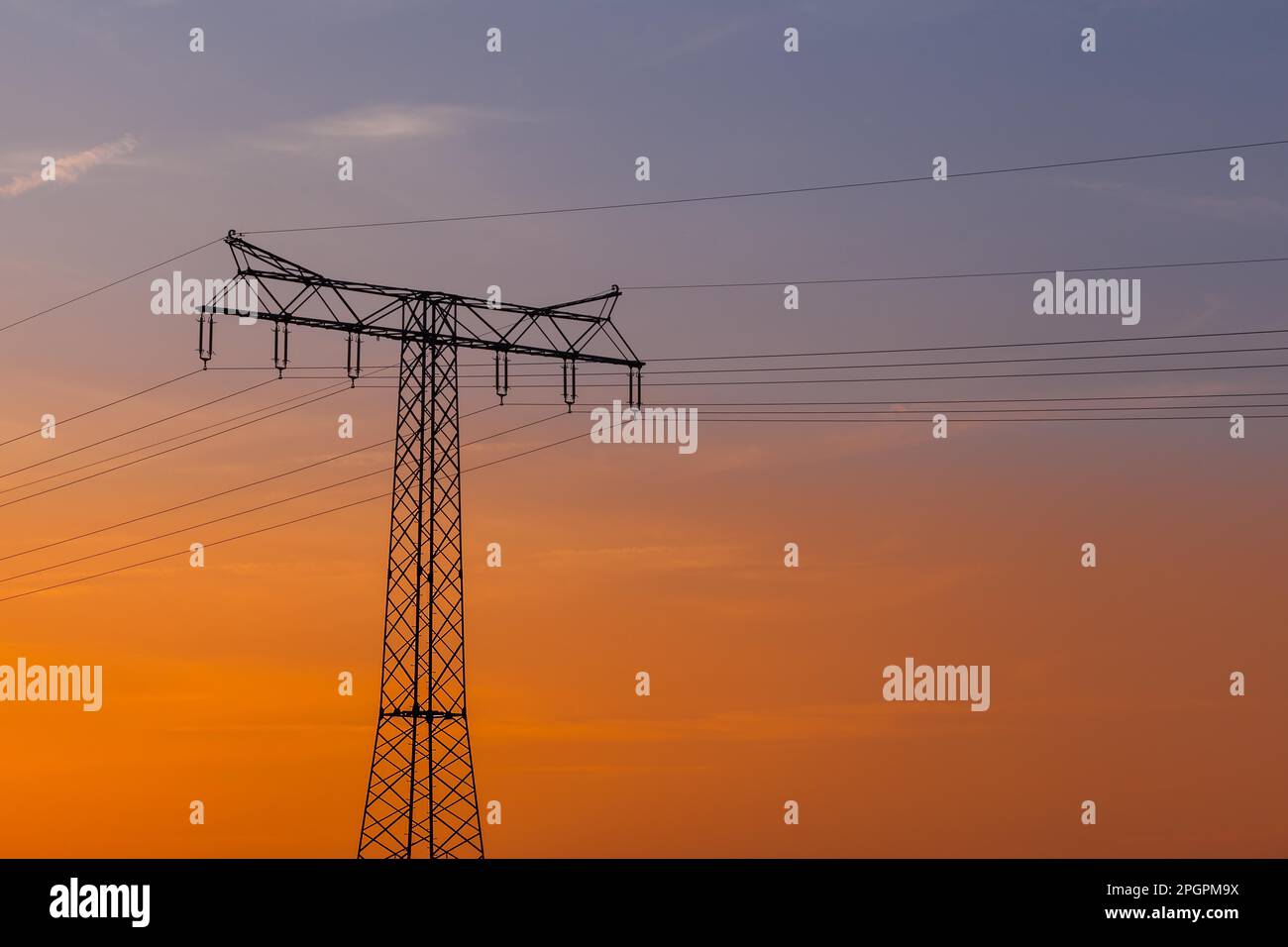 Highvoltage power line Highvoltage pylon in the sunset Stock Photo